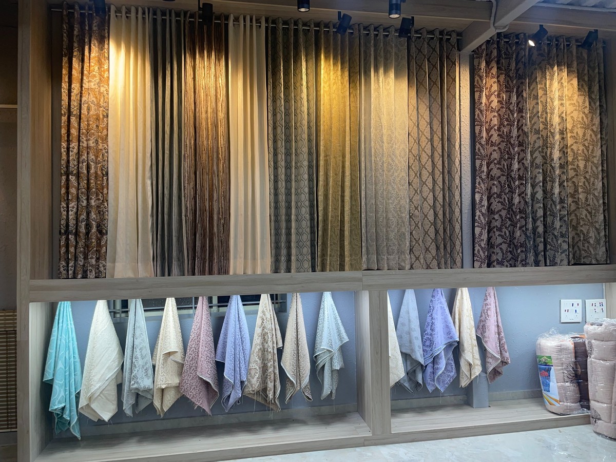 Layered curtains and wall mural in a Nanak Furnishings showroom display